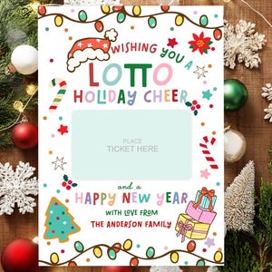 May include: A festive Christmas-themed card with the words "Wishing you a Lotto Holiday Cheer" in colorful letters. The card features a space for a ticket, a Christmas tree, and gift illustrations. The text "Happy New Year" and "With love from The Anderson Family" are also included.