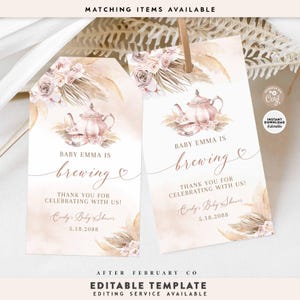 May include: A printable baby shower favor tag with a watercolor illustration of a teapot, flowers, and pampas grass. The text reads "Baby Emma is brewing" and "Thank you for celebrating with us!" with the date "5.18.2088".