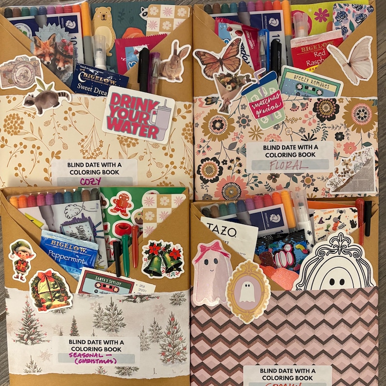 May include: Four decorated brown paper envelopes, each labeled "Blind Date with a Coloring Book." The envelopes are filled with markers, stickers, and tea bags. Themes include "Cozy," "Floral," "Seasonal (Christmas)," and "Spooky."