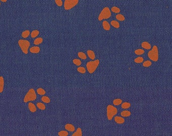Orange Tiger paw on purple denim fabric from Fabric Finders, orange paw print denim, orange paw print fabric by the yard for sewing apparel