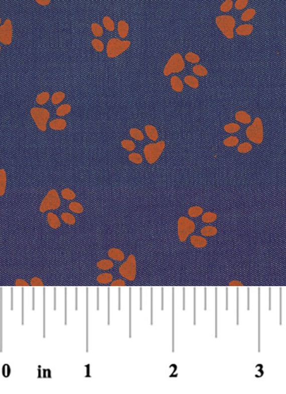 Orange Tiger paw on purple denim fabric from Fabric Finders, orange paw print denim, orange paw print fabric by the yard for sewing apparel