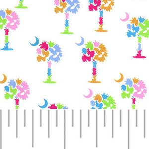 May include: White fabric with a repeating pattern of colorful palm trees and crescent moons. The fabric is measured with a ruler in inches.