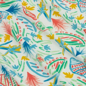 May include: White fabric with a colorful abstract pattern of green, blue, red, and yellow. The pattern features stylized plants and seashells.