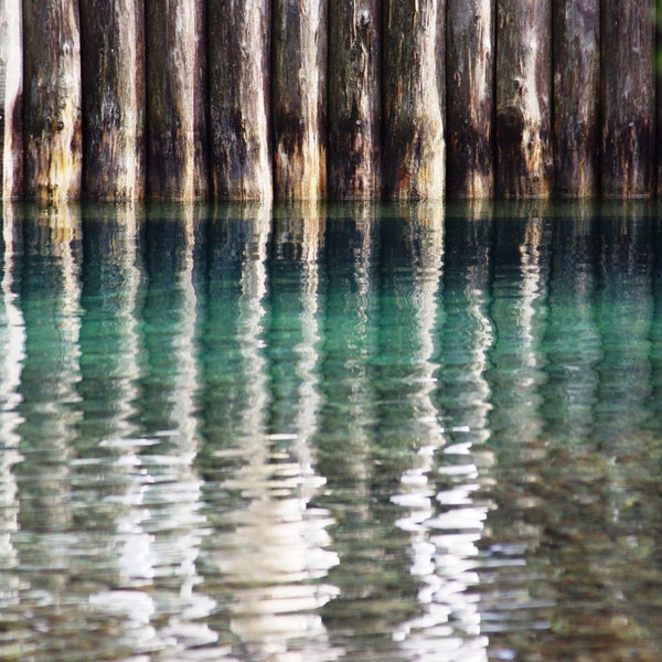 An unusual shot of posts from a jetty being reflected in very clear water. An interesting effect with curious colouring.