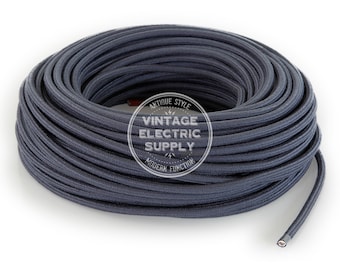 May include: A coil of dark gray electrical wire. The wire is wrapped in a fabric sheath and has a visible copper core at the end. The image includes a logo that reads "Antique Style Vintage Electric Supply Modern Function."