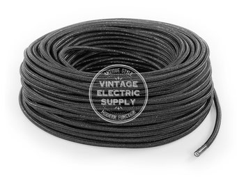 May include: A spool of black electrical cord with a white label that reads "Vintage Electric Supply".