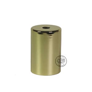 May include: A gold metal ceiling fixture adapter with a smooth, shiny finish. The adapter is cylindrical in shape and has a small hole in the top.