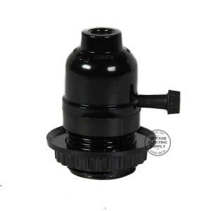 May include: Black plastic electrical socket with a side switch. The socket is designed for use with standard light bulbs.