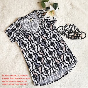 May include: A black, white, gray, and pink patterned V-neck t-shirt and matching face mask. The pattern features a repeating abstract design. The text on the image reads: "IF YOU HAVE A T-SHIRT FROM ANTHROPOLOGIE, MATCHING FABRIC IS USED FOR THE MASK!"