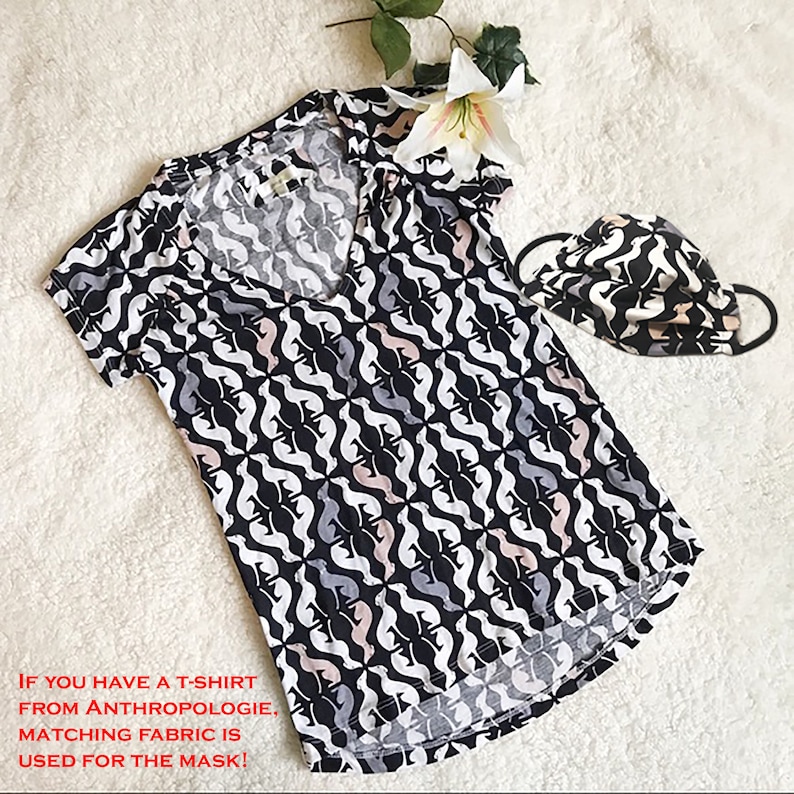 May include: A black, white, gray, and pink patterned V-neck t-shirt and matching face mask. The pattern features a repeating abstract design. The text on the image reads: "IF YOU HAVE A T-SHIRT FROM ANTHROPOLOGIE, MATCHING FABRIC IS USED FOR THE MASK!"