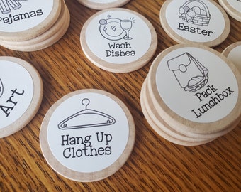 May include: A set of wooden tokens with various chores written on them, including "Hang Up Clothes", "Wash Dishes", "Pack Lunchbox", "Art", "Pyjamas", and "Easter".