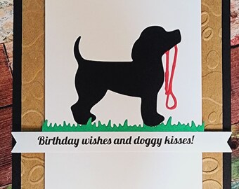 Dog wishing 'Birthday wishes and doggy kisses'. ready for a walk.