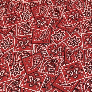 May include: Red and white bandana print fabric with a repeating pattern. The fabric is made of cotton and is perfect for quilting, crafts, and other projects.