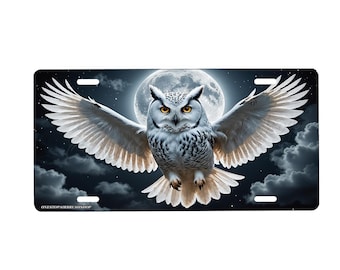 May include: A white snowy owl with yellow eyes is flying with its wings spread wide against a dark blue night sky with a full moon in the background. The owl is in focus and the moon and sky are blurred.