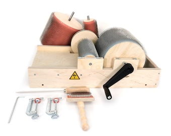 May include: A wooden wool carding machine with a black crank handle, two carding cylinders, and a wooden brush. The machine is accompanied by three clamps, a metal rod, and a wooden comb.