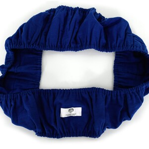 May include: A blue fitted chair cover with elastic edges. The cover has a white label with the text "Golden Fleece Furniture" on it.