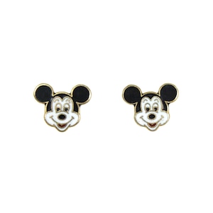 May include: A pair of Mickey Mouse stud earrings. Each earring features a gold-colored border with a black head and ears, a white face, and a red mouth. The earrings are set against a white background.