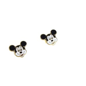 May include: Two gold-toned Mickey Mouse face stud earrings. Each earring features a black head with white facial features and a gold border. The earrings are set against a white background.