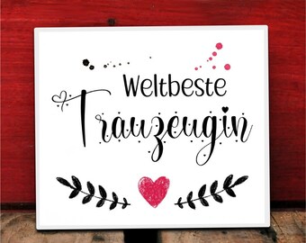 May include: White sign with black text that reads "Weltbeste Trauzeugin" with a pink heart and black floral accents.