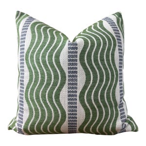 May include: Green and white striped pillow with a wavy pattern. The pillow has a blue and white stripe down the center.