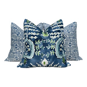 May include: Three decorative throw pillows with blue and green patterns. The center pillow features a floral design with white accents. The two side pillows have a geometric pattern in shades of blue.