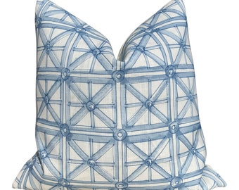 May include: A blue and white geometric patterned throw pillow with a square shape. The pattern is a grid of squares with a circle in the center of each square. The circles are connected by lines that form a star shape.