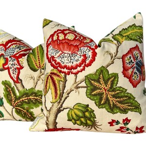 May include: Two cream-colored pillow covers with a floral pattern. The pattern features large red and pink flowers with green leaves on a cream background.