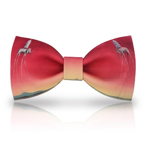 May include: Red bow tie with a surrealist painting of elephants with long legs on a sunset background.