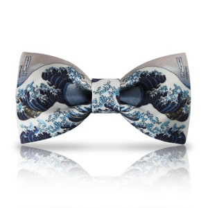 May include: A blue and white bow tie with a print of the Great Wave off Kanagawa by Katsushika Hokusai.