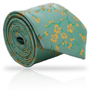 May include: A rolled-up necktie featuring a repeating pattern of yellow floral branches on a light teal background. The tie is made of a smooth fabric and is suitable for formal or business attire.