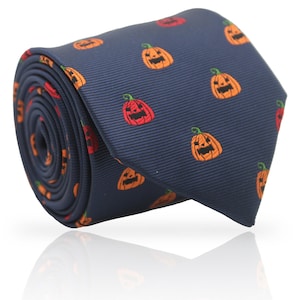 May include: Navy blue necktie featuring a repeating pattern of orange and red jack-o'-lanterns. The tie is rolled up, showcasing the fabric's texture and the festive Halloween design. A stylish accessory for seasonal celebrations.
