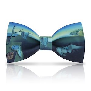 May include: A blue bow tie with a printed design of Salvador Dali's "The Persistence of Memory".