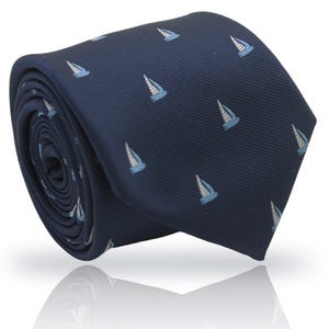 May include: Rolled navy blue tie with a repeating pattern of small sailboats in light blue and white. The tie is made of a smooth fabric and is suitable for formal or casual wear.