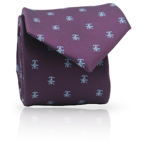 May include: A folded purple tie featuring a repeating light blue floral pattern. The tie is made of a smooth fabric and is neatly folded, showcasing the design. A classic accessory for formal wear.