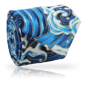 May include: Rolled necktie with a blue wave pattern. The tie features shades of blue, white, and gold, creating a dynamic and artistic design. The fabric is tightly rolled, showcasing the intricate pattern and texture of the material.