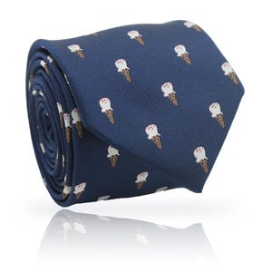 May include: Rolled navy blue tie featuring a repeating pattern of ice cream cones. The ice cream cones have white scoops with a pink cherry on top and brown waffle cones. The tie is made of a smooth fabric and is suitable for formal or casual wear.