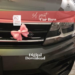 May include: A pink 3D printed bow attached to the front grille of a dark gray car. The image includes an STL file icon, the text 3d print Car Bow, and the text Digital Download. The bow features a smooth, rounded design with a central knot.