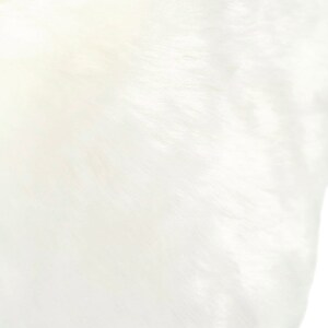 May include: A close-up of a white, smooth, and textured fabric. The fabric has a subtle sheen and a soft, luxurious feel.
