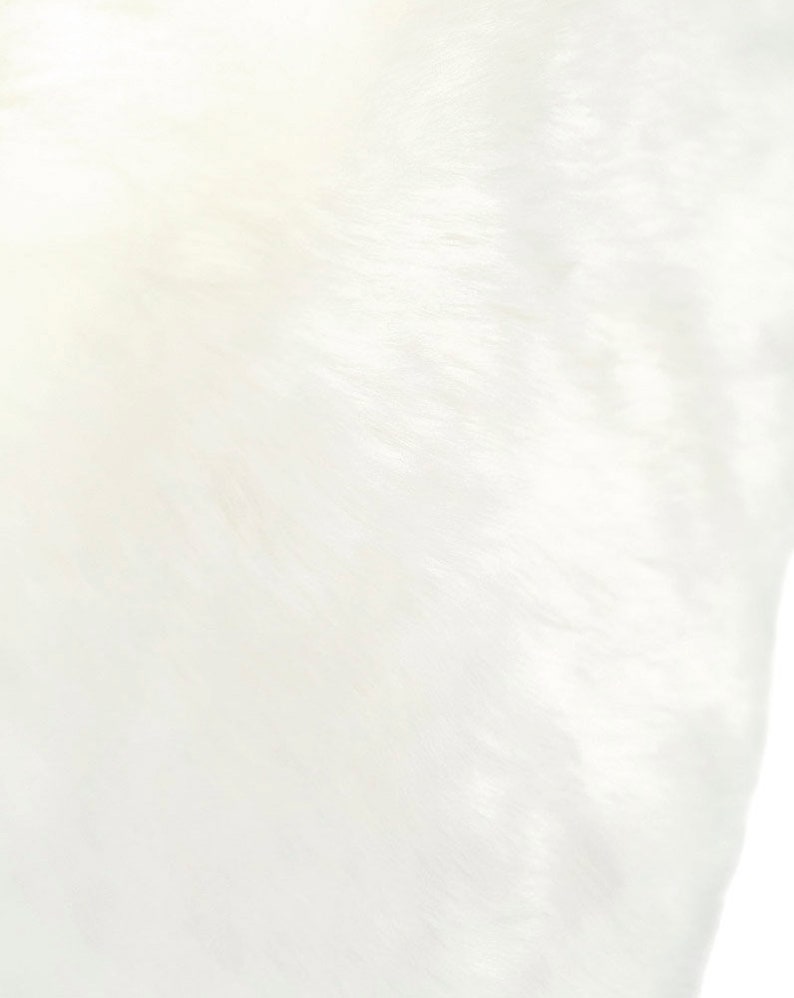 May include: A close-up of a white, smooth, and textured fabric. The fabric has a subtle sheen and a soft, luxurious feel.