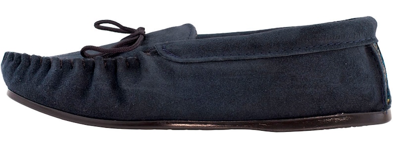 May include: A pair of dark blue suede moccasins with a leather sole and a decorative bow on the top.
