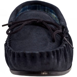 May include: A pair of navy blue suede moccasins with a black leather sole and a black lace tie.