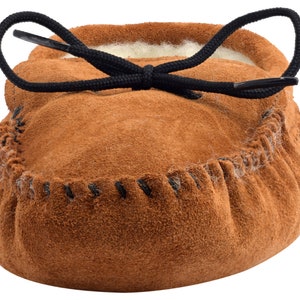 May include: Brown suede moccasin slippers with a black drawstring closure and a white fleece lining.