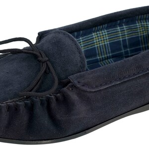 May include: Navy blue suede moccasins with a black tassel and a plaid lining.