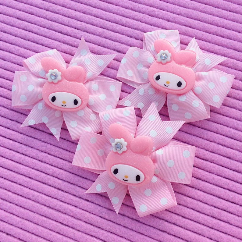 Kawaii pink polka dot grosgrain bow with glittery resin bunny head charm