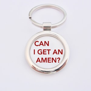 May include: Silver keychain with a round white tag that says "CAN I GET AN AMEN?" in red letters.