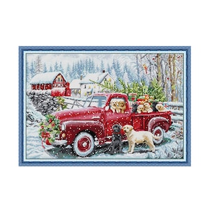 May include: A cross-stitch pattern depicting a red vintage pickup truck in a snowy landscape. The truck bed holds several puppies and a Christmas tree. Two adult dogs, one black and one yellow, stand beside the truck near a red barn.