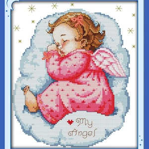 Puede incluir: Diseño de punto de cruz de un bebé ángel durmiendo con un atuendo rosa y alas blancas, descansando sobre una nube. El texto "My Angel" está debajo. El fondo tiene estrellas y un borde azul.