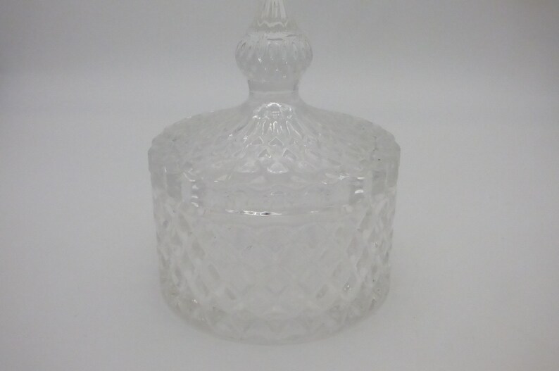 May include: A clear glass jar with a lid. The jar and lid have a diamond pattern.