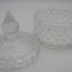 May include: A clear glass jar with a lid. The jar has a diamond pattern and the lid has a decorative knob.