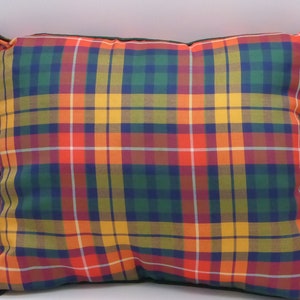 May include: A red, yellow, green, and blue plaid pillow with a dark green border.